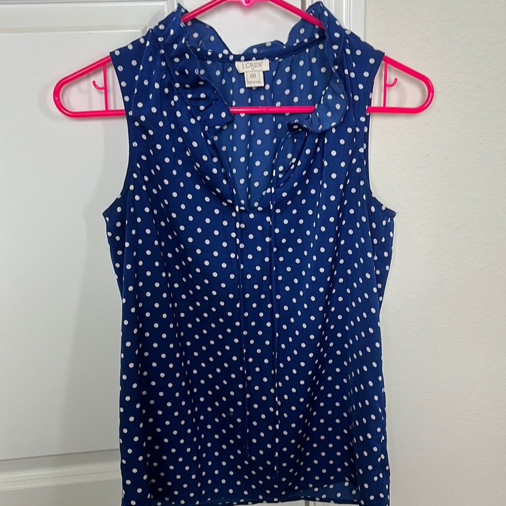 Jcrew blue and white polka dot sleeveless blouse.